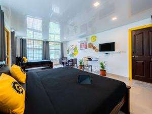 a bedroom with a bed and a living room at The Hosteller Coorg, Madikeri in Madikeri