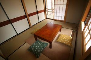 a small room with a wooden table and a bench at 北軽井沢の貸別荘一棟貸し切り-庭とウッドデッキつき in Azumaiokozan