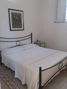 a bedroom with a large white bed in a room at Carlotta Home in Marsala