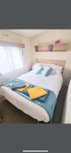 a bedroom with a bed with towels on it at Sea let’s selsey in Selsey
