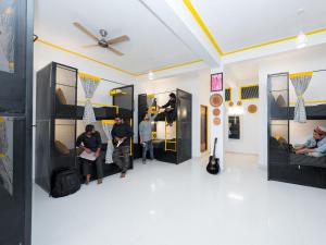 a group of people standing in a room at The Hosteller Coorg, Madikeri in Madikeri