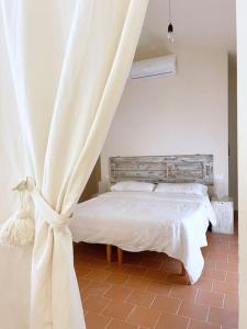 a bedroom with a bed with a curtain at Casa Barulli - Tuscany in San Giovanni Valdarno