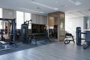 a gym with treadmills and exercise equipment in a room at Platinum Hotel Tunjungan Surabaya in Surabaya