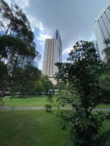 a view of a park with a tall building at KLCC Studio One Bedroom in Kuala Lumpur
