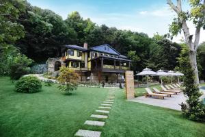 a large house with a lawn in front of it at Casa Giallo in Sapanca