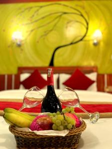 a basket of fruit and a bottle of wine on a table at Thamel Seasons Hotel in Kathmandu