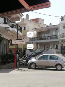 a car parked in a parking lot in front of buildings at Fillitsa's Sweet Home in Neos Marmaras +17 photos