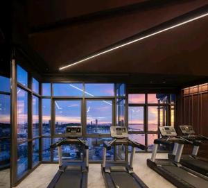 a gym with two treadmill desks and a view of the city at Edge Central Pattaya Condo in Pattaya Central