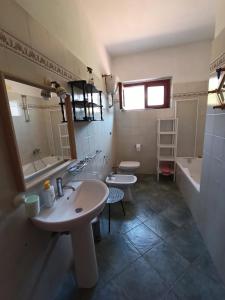 a bathroom with two sinks and two toilets at Padullella, mare e sole!! in Portoferraio