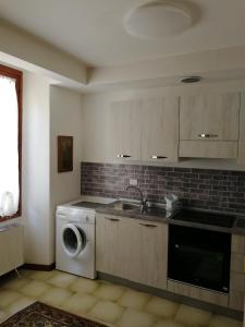 a kitchen with a sink and a washing machine at App Angela - Ponale 3 in Riva del Garda