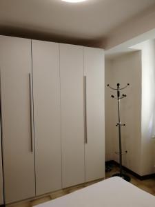 a bedroom with white cabinets and a bed at App Angela - Ponale 3 in Riva del Garda