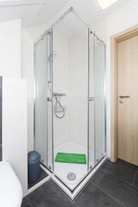 a shower with a glass enclosure in a bathroom at Ferienwohnungen Haus Hasenweide in Stedesdorf