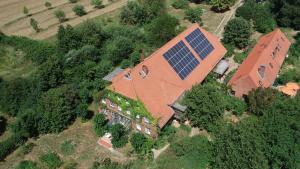 an aerial view of a large house with a solar roof at Privelacker Paradiesgarten 