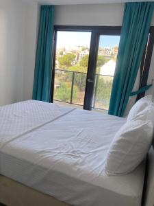 Ένα ή περισσότερα κρεβάτια σε δωμάτιο στο Sahil Aparts - Güllük