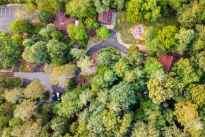 an overhead view of a park with trees and a road at Log Cabin Motor Court in Asheville