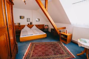 ein kleines Schlafzimmer mit einem Bett und einem Teppich in der Unterkunft Bio-Weingut Staffelter Hof in Kröv