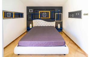 a bedroom with a large bed with purple sheets at Villa Sara in Ragusa +23 photos