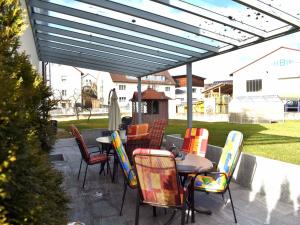 a patio with a table and chairs under awning at Bögi's Ferienwohnung in Leipheim