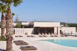 a hotel with a swimming pool and a resort at Elissa Adults-Only Lifestyle Beach Resort in Kallithea Rhodes