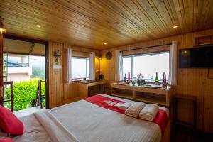 a bedroom with a large bed in a wooden room at Syamantac Villa in Kodaikānāl