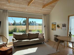 a living room with a couch and a table at Soda Home - The Tiny House - 24h check in in Närpiö