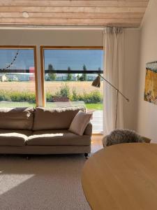 a living room with a couch and a large window at Soda Home - The Tiny House - 24h check in in Närpiö