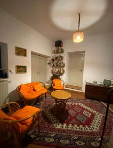 a living room with orange chairs and a table at Casa sulla Cascata delle Marmore - con vista in Torre Orsina