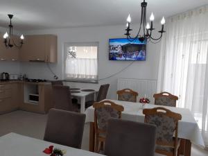 uma cozinha e sala de jantar com mesa e cadeiras em Casa Anna em Borşa