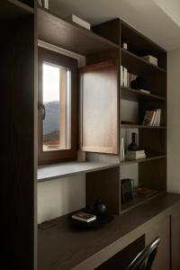 a room with a window and a desk with a window at The Storyteller Boutique House in Kalabaka
