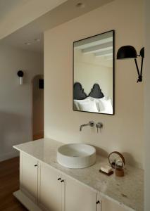 a bathroom with a sink and a mirror at The Storyteller Boutique House in Kalabaka