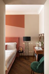 a bedroom with a bed and a table and a desk at Boutique Hotel Galatea in Rome
