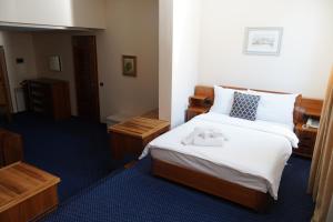 a hotel room with a bed with towels on it at Hotel Brass in Sarajevo