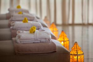 a row of towels lined up in a row with lights at King Evelthon Beach Hotel & Resort in Paphos