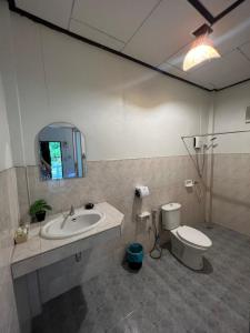 a bathroom with a sink and a toilet and a mirror at Sonic Hill Koh Phangan in Haad Rin