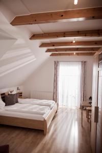 a bedroom with a large bed and a large window at Bio Weingut Matthias Schnabl in Gamlitz