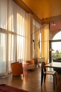 a living room with a table and chairs at Tsinandali Estate Villa Collection in Tsinandali