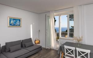 a living room with a couch and a table at D Place in Dubrovnik