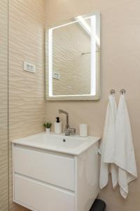 a bathroom with a white sink and a mirror at D Place in Dubrovnik +7 photos