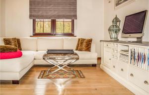 a living room with a white couch and a table at Beautiful Home In Golczewo in Golczewo