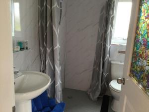 a bathroom with a sink and a toilet at Colourful Mongolian Yurt enjoy a new experience in Turriff