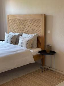 a bedroom with a large bed and a table at Villa Kapela in Zlarin +34 photos