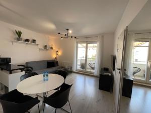 a living room with a table and a couch at Modern Box Apartment in Gdynia