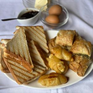 a plate of food with bread and eggs on a table at Traditional Guesthouse Vrigiis in Agios Germanos