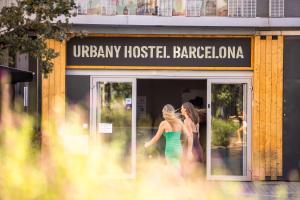 two women walking in the doorway of a boutique at Urbany Hostel Barcelona in Barcelona