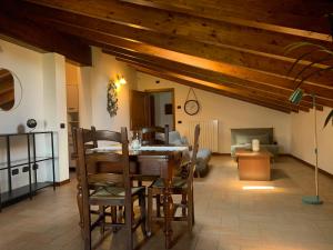 a living room with a wooden table and chairs at Borgo La Morra in Pavullo nel Frignano