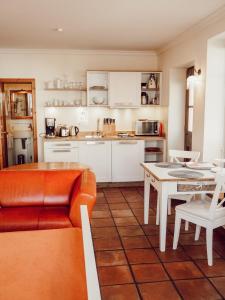 eine Küche und ein Wohnzimmer mit einer Couch und einem Tisch in der Unterkunft Backsteinparadies in Lüneburg