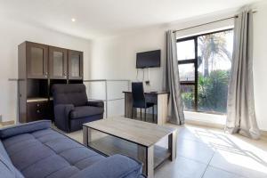 a living room with a couch and a table at Linden Guest House in Johannesburg