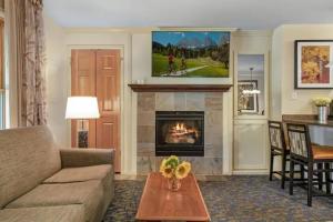 a living room with a couch and a fireplace at Aspen at Streamside at Vail in Vail