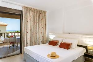 a bedroom with a bed and a balcony at 3Aktes Suites & Studios in Syvota
