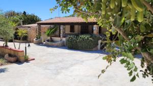 a house with a courtyard with a patio at Mamalù Deluxe in Lampedusa